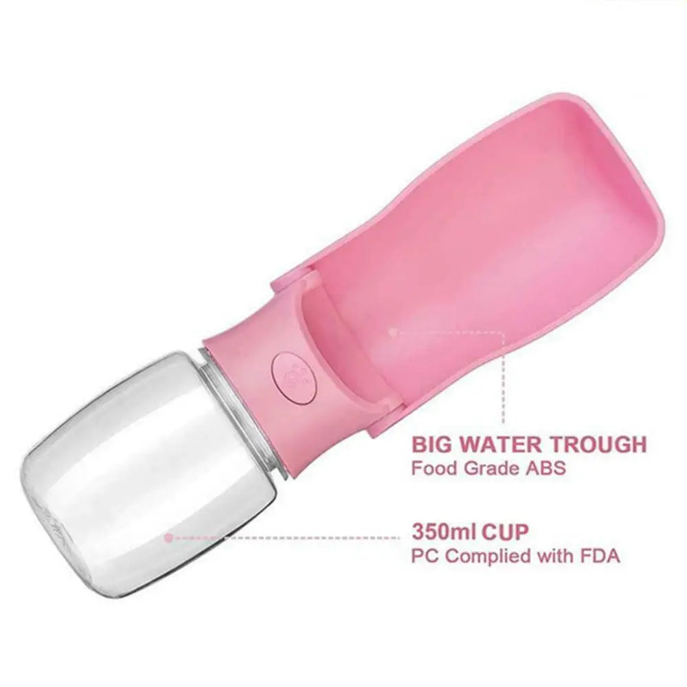 pink portable water and food bottle for dogs and cats. There is text that points to the container "350ml CUP PC Complied with FDA" and another text pointing to the tray says "BIG WATER TROUGH Food Grade ABS"