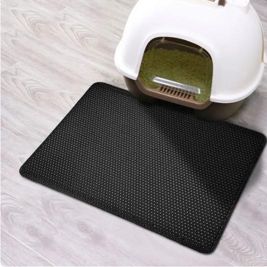 black cat litter mat/pad and a litter box with a background of a floor